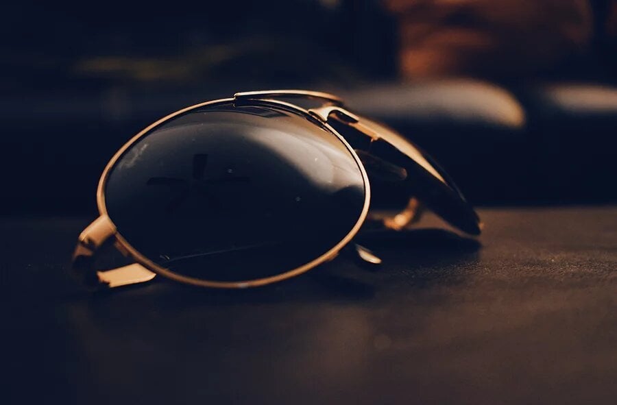 sunglasses on wood dark background