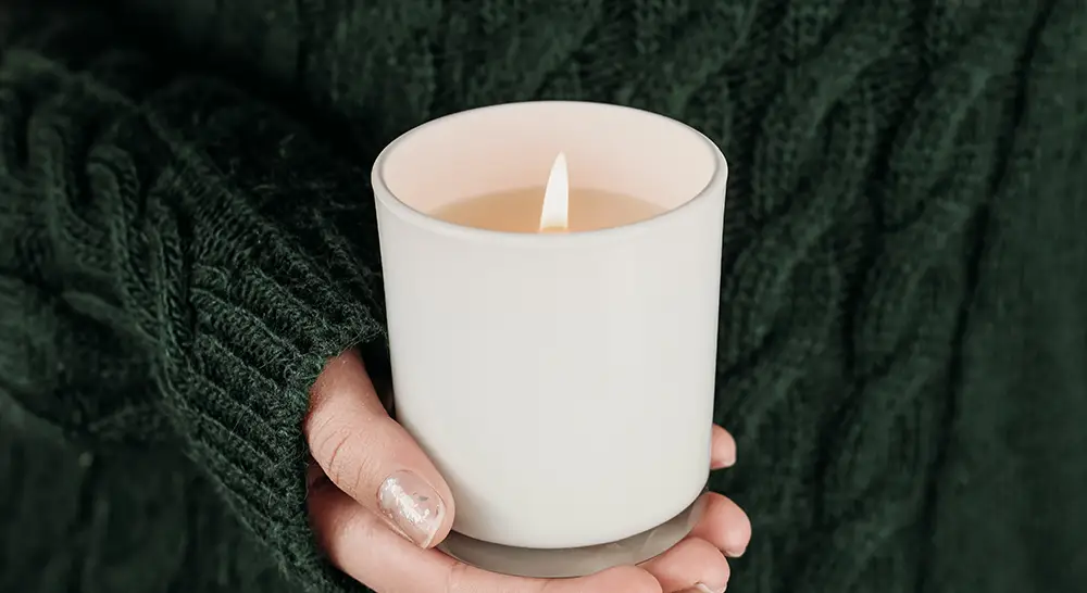 a-picture-of-a-woman-holding-a-soy-candle