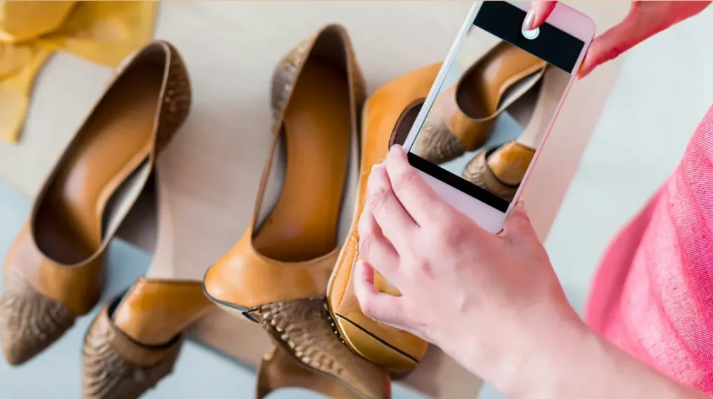 a-person-taking-a-picture-of-shoes-with-a-cell-phone