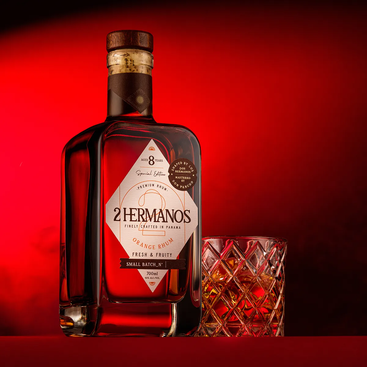 2-hermanos-orange-rum-8-year-special-edition-red-background-studio-shot.webp